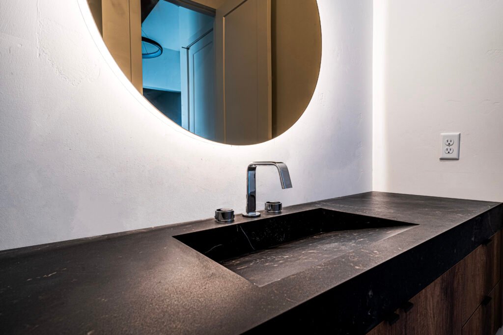 Integrated sink design in powder room with Dekton Kelya countertop.